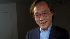 Frank Hu holds a plate filled with food. 