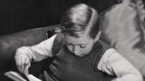 Photo of a young boy reading a book