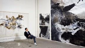 Artist Shen Wei in his studio amid his large-scale abstract paintings 