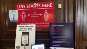 Photograph of posters displaying coronavirus rules at the entrance to Adams House dining hall.