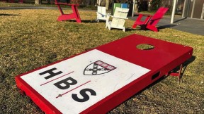 Harvard Business School logo on a campus cornhole board