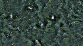 Part of the Perseus molecular cloud, as seen through the Smithsonian’s MMT telescope in Arizona. Self-gravitating structures—dense areas where stars are forming—appear as dark spots. The L1448 region is located in the upper-right quadrant of the image.