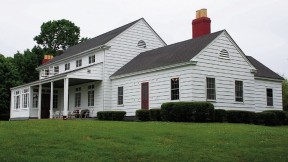 The dining hall of the Harvard crew’s training camp, with its game-room addition at right, overlooks the Thames river.