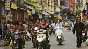 Hanoi&rsquo;s streets (in 2007, above) are now full of motorcycles and scooters, and shop shelves are no longer bare.