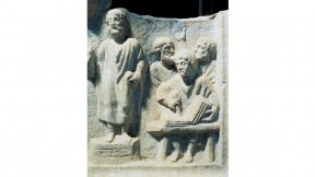 Photograph of a carved relief showing orator dictating to a scribe, from the fourth-century Roman Temple of Hercules at Ostia Antica