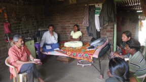 Photograph of Vikram Patel visiting with family members of a farmer in Maharashtra, India, who committed suicide
