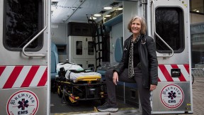 Pediatrician Eileen Costello stands next to the Boston Medical Center’s mobile pediatric clinic.