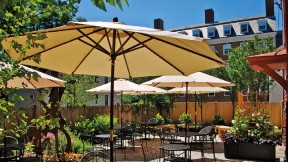 sunny patio with umbrellas over tables