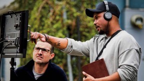 Screenwriter Julian Breece working with a colleague on set