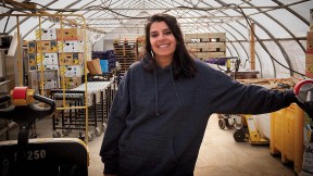 Usha Thakrar standing in the greenhouse production center at Stonefield Farm