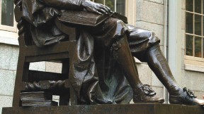 The John Harvard statue, with books at hand