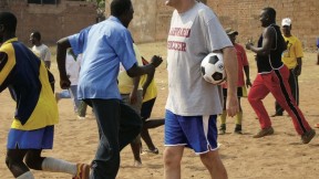 Nick Gates ’91, who founded Coaches Across Continents, works with coaches (above) and youths (at right) in Tanzania in 2009. 