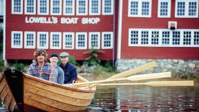 Graham McKay (front) with Jim Heller and Justin Kennick launching one of the shop's boats on the Merrimack River
