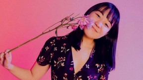 Karen Chee holding a flower to her face