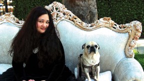 Author Gabrielle Zevin seated on a sofa in Los Angeles with her dog Nico