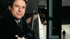 Richard Peña at Lincoln Center, with a New York Film Festival banner at right, behind him
