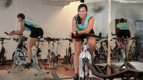 Murdock Stenis warms up for indoor cycling, an intense interval  workout with music.