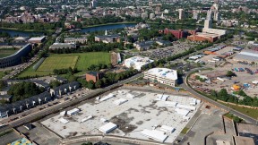 From a vantage point south of Western Avenue in Allston, looking northeast toward Harvard Square, the unfinished science complex dominates the foreground. Beyond it lie athletic fields that may yield to expansion by the School of Public Health, the Graduate School of Education, or other academic enterprises. A business “enterprise research campus” is envisioned south of Western Avenue, across from the high-rise graduate-student housing at One Western Avenue.