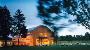 Seiji Ozawa Hall at Tanglewood, the summer home of the Boston Symphony Orchestra, in Lenox, Massachusetts. The hall opened in 1994. With the &ldquo;barn door&rdquo; open, picnickers enjoy a concert.