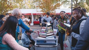 People perusing books outside at the Boston Book Festival 