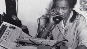 Black journalist Claudia Jones on the phone in the offices of the “West Indian Gazette” in London
