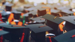 Photograph of students in caps and gowns graduating from college
