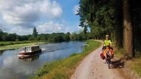 Michael Lyon and son ride a bike next to a river.