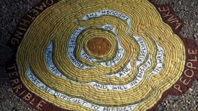 An image from Gilens's "Reading Forest"  installation, a sketched cross-section of a tress with words interspersed in the rings. They read: "The effects of climate change are rippling through the landscape and will intensify in ways that are difficult to predict."