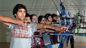 Samuel Saidel-Goley (foreground) and Archery Club colleagues draw their bows.