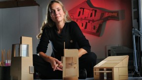 Elizabeth Whittaker, at her office in Boston, with basswood architectural models for residential and commercial structures