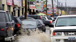 Puddles of water, a leitmotif in <i>Foreign Parts,</i> fill the rutted streets of Willets Point in Queens, a mecca for auto repair and parts.