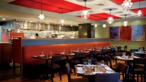 Evoo’s earthy food is served in a modern, open interior with a view of the kitchen.