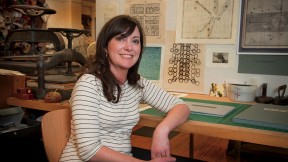 Hulsey in her studio, with letterpress machines behind her