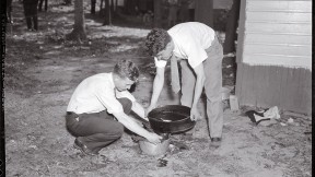 Forensic pioneer Joseph T. Walker (at left) collects blood and scraps of flesh from the bathtub drain of a 1936 murder victim.