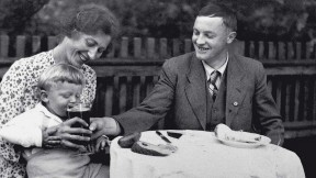 Black-and-white photograph of Karl Puchner in 1937 with his wife, young son, and a tiny, barely visible swastika button on his jacket