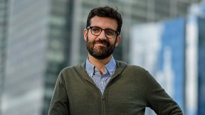 Bruno Carvalho stands in front of a city background