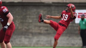 Jon Sot punts a football.