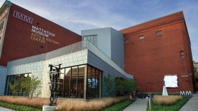glass and steel addition to a traditional brick building that houses the Mattatuck Museum