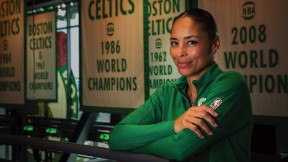 Allison Feaster wearing a green Celtics shirt in front of team championship banners