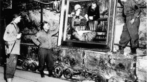 At the Merkers salt mines in central Germany, American GIs admire Édouard Manet’s <em>In the Conservatory,</em> one of the thousands of rare works and documents stored there by the Nazi regime late in World War II. Monuments Man George Stout (see next image), a Fogg Museum conservator turned U.S. Army lieutenant, supervised the rescue of 40 tons of art from the site in April 1945.