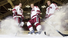Hard-skating brothers Danny, Alex, and Michael Biega (left to right) spray ice chips at Bright Hockey Center.