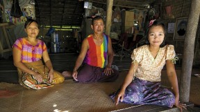 Daw Than Than Sein, U Win Hlaing, and daughter Win Win Thu at their home in the Ayeyarwaddy River Delta village of Wakouktaw; Proximity Designs&rsquo; irrigation equipment has helped them expand their farm and boost their income significantly. 