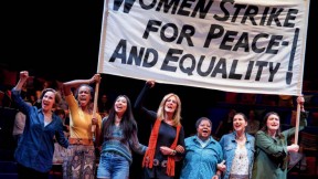 Scene from "Gloria, A Life," showing women marching in solidarity with protest sign