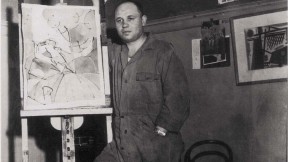 Photograph of artist Romare Bearden standing by an easel c. 1940