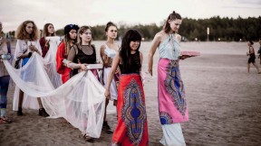 A procession of women heading toward a lake