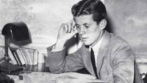Archival photograph of John F. Kennedy as an undergraduate, circa 1939, studying papers