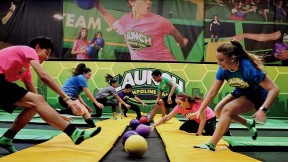 People playing dodgeball on indoor trampolines 