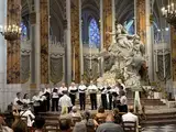 A group of choir singers performs in a cathedral