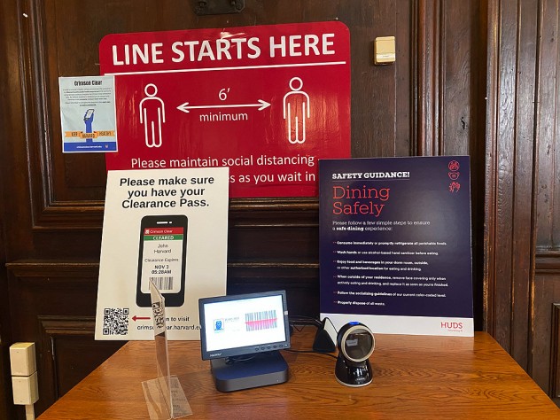 Signs outside the dormitory dining hall specifying rules for access and the need for social distancing.