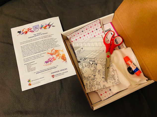 A Collegesupplied collage kit, with scissors, a marker, sheets of paper, and a flyer affirming community.